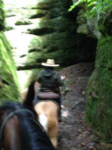 Sue walking in between a crevace into this enclosed rock space